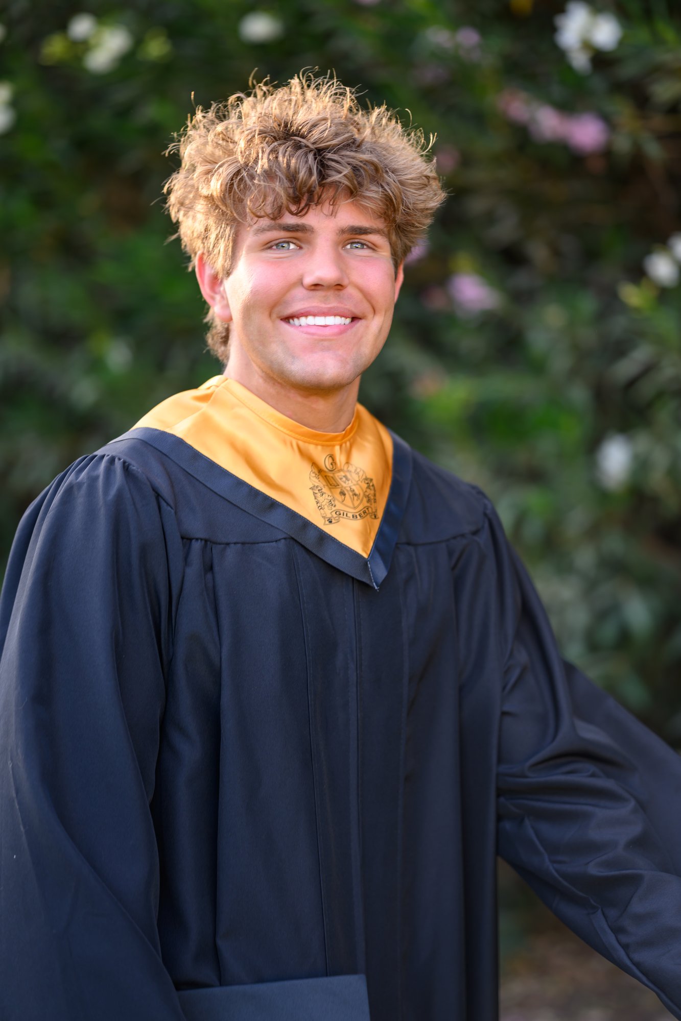 Senior boy in cap and gown with honors stole